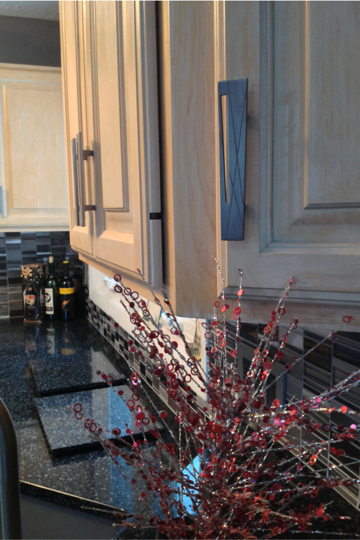 Distressed kitchen cabinets with black Cambria countertops 