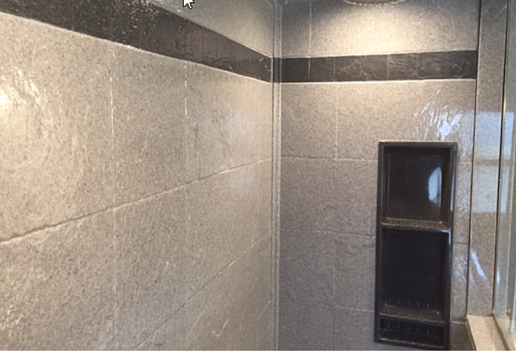 Decorative striped border in a DIY shower wall panel system in a 12 x 12 tile design