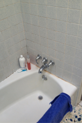 Old tub and tile surround in a Fairview park ohio bathroom before remodeling 