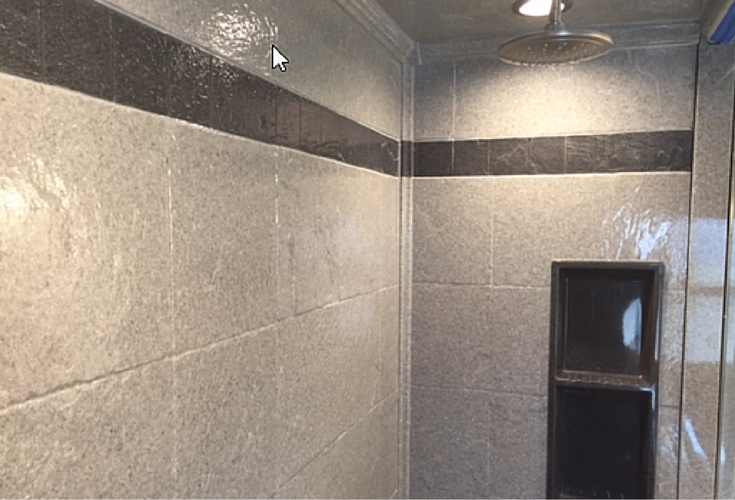 Solid surface stone tile pattern wall panels with a decorative tile trim border 