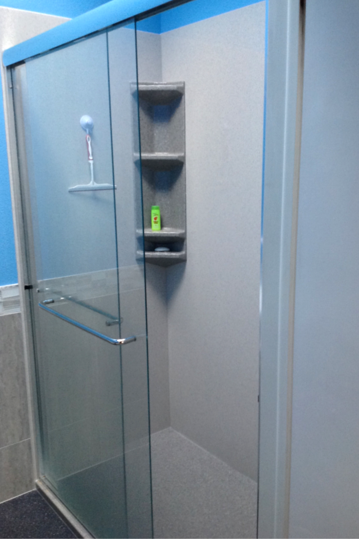 Tub to shower conversion with a stone solid surface shower wall panel and pan system 