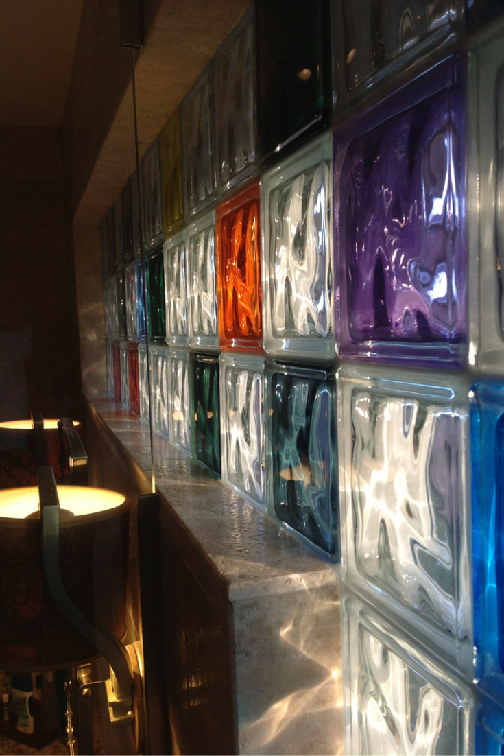 A colored glass block transom window wall in a small bathroom for light in Columbus Ohio 