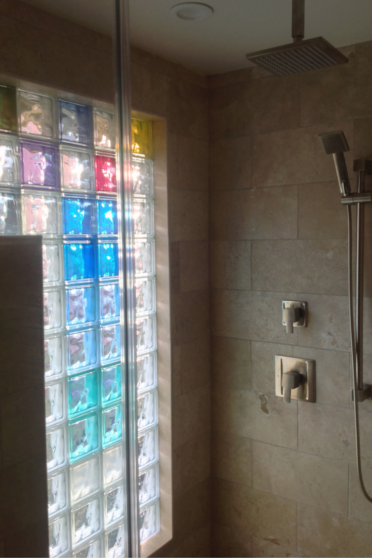 Colored glass block shower wall gives privacy and light for a small bathroom in columbus ohio