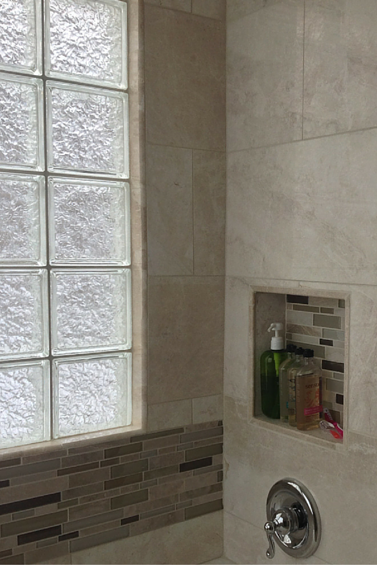 Recessed niches placed lower in a bathroom to make them easier to reach for someone in a wheelchair 