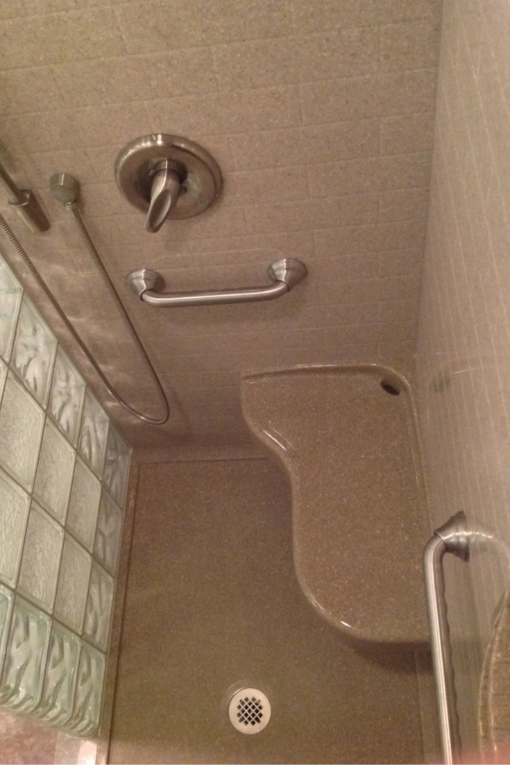 extended 26 x 16 solid surface seat in an accessible shower remodel in akron