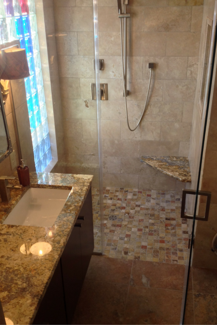 Bexley area of Columbus bathroom remodel with a custom tile shower and colored glass blocks for a window wall 