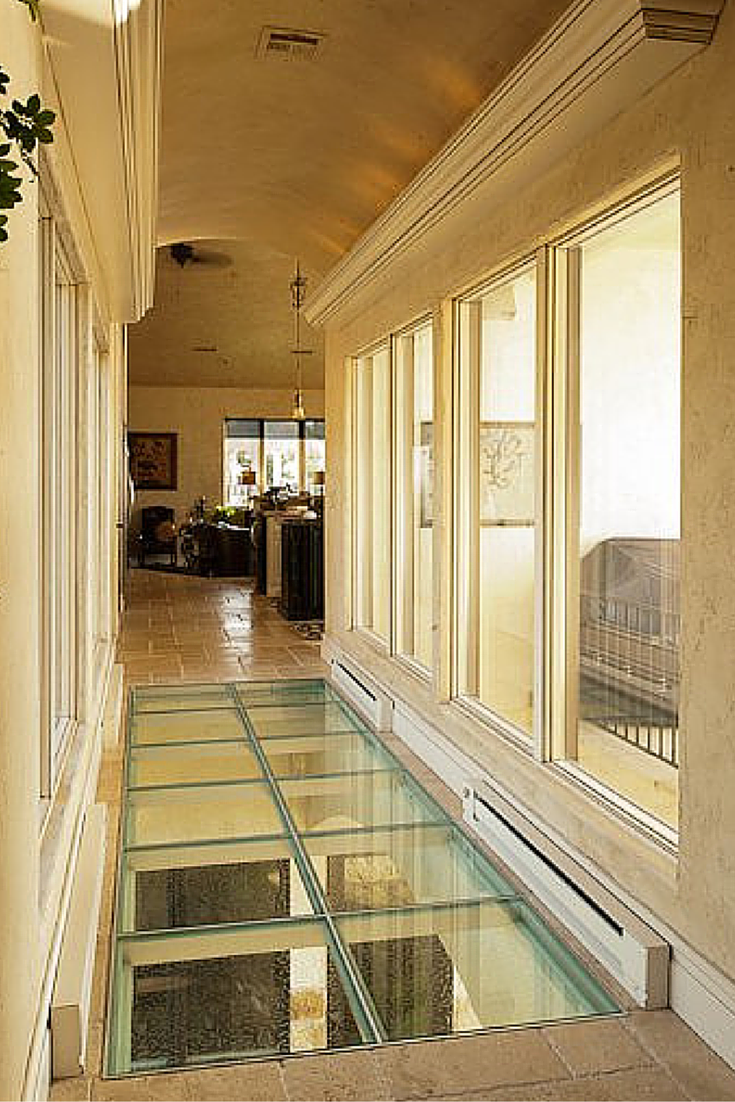 Glass flooring bridge in an upscale luxury home 