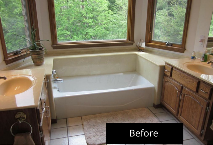 1980's Jack and Jill bathroom in Powell Ohio before remodeling with an outdated soaking tub and clear window with no privacy 