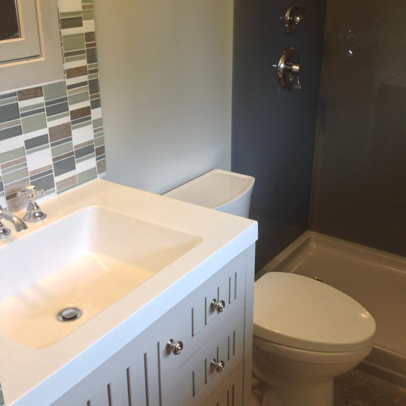 country vanity with modern high gloss acrylic shower walls in a columbus bathroom 