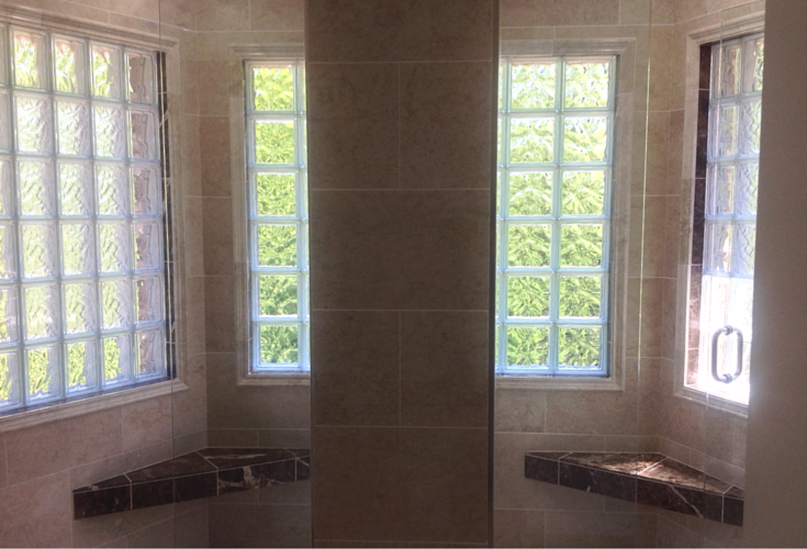 dual bench seats in a larger shower in a jack and jill bathroom 