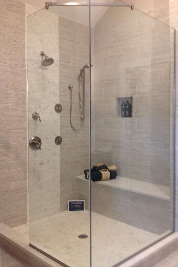 Vertical tile row creates an interesting design in a bathroom with a vaulted ceiling 