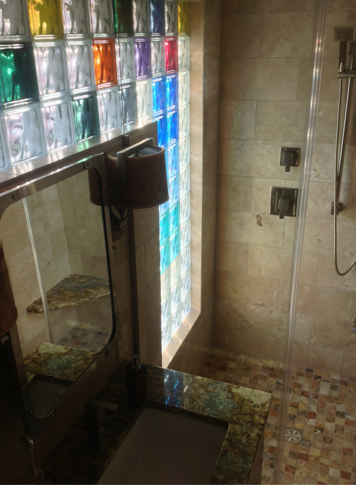 Colored glass block high privacy shower window for light and privacy in a first floor shower. Project by Innovate Building Solutions