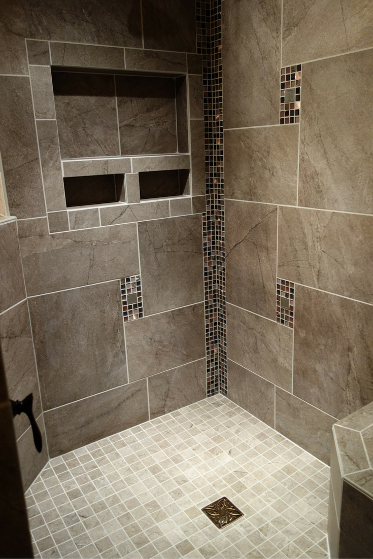 Large recessed niches in a custom tile shower with a no curb barrier free entry Innovate Building Solutions 