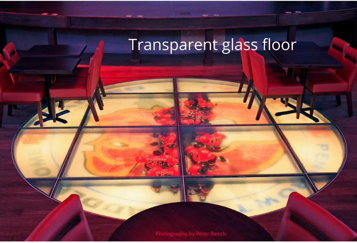 Transparent glass flooring in a lounge in a hockey arena 