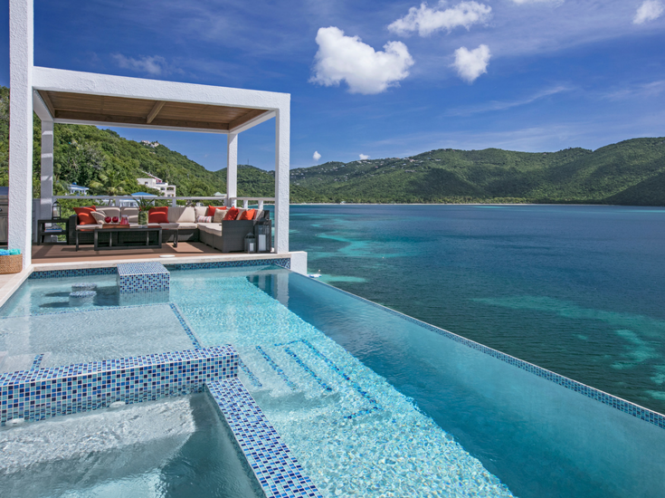 A daytime view of an infinity pool overlooking Magen's Bay in St. Thomas - @InnovateBuild