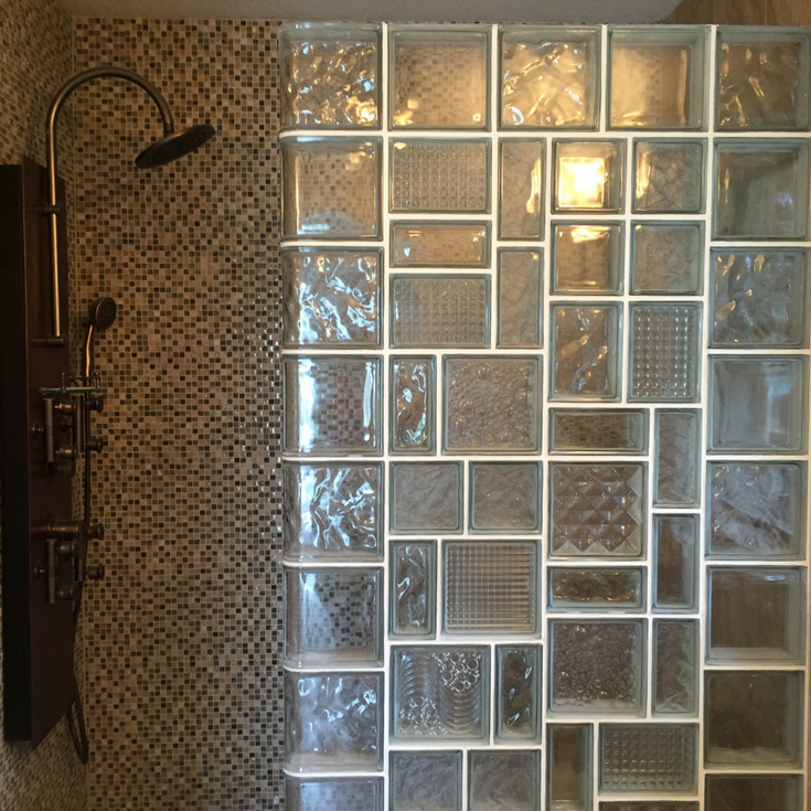 Glass block shower wall with multiple sizes and patterns for a leaded glass type look in a tile shower. | Innovate Building Solutions