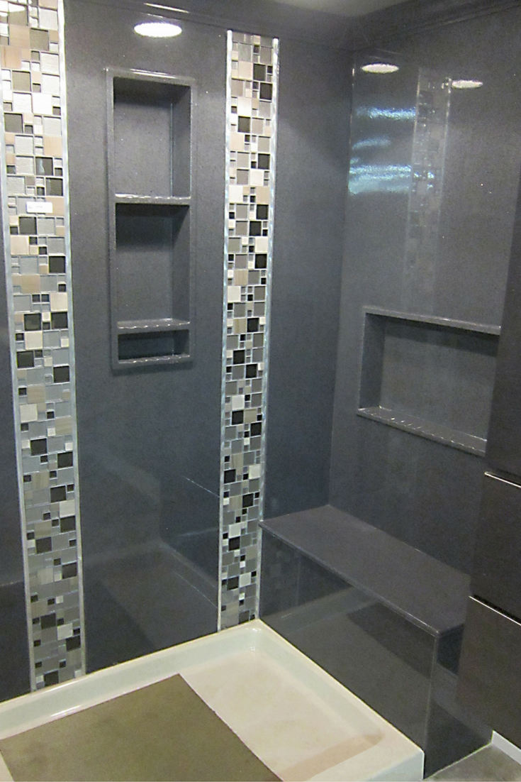 Gray colored cultured marble solid surface shower panels with a decorative vertical tile strip border - Innovate Building Solutions 