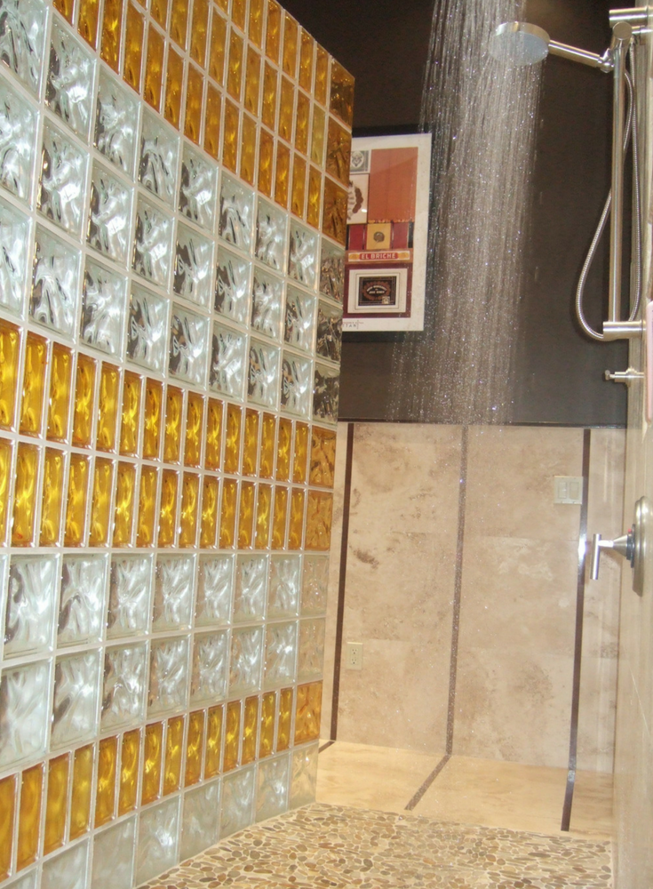 Colored and curved glass block shower with different sized blocks | Innovate Building Solutions 