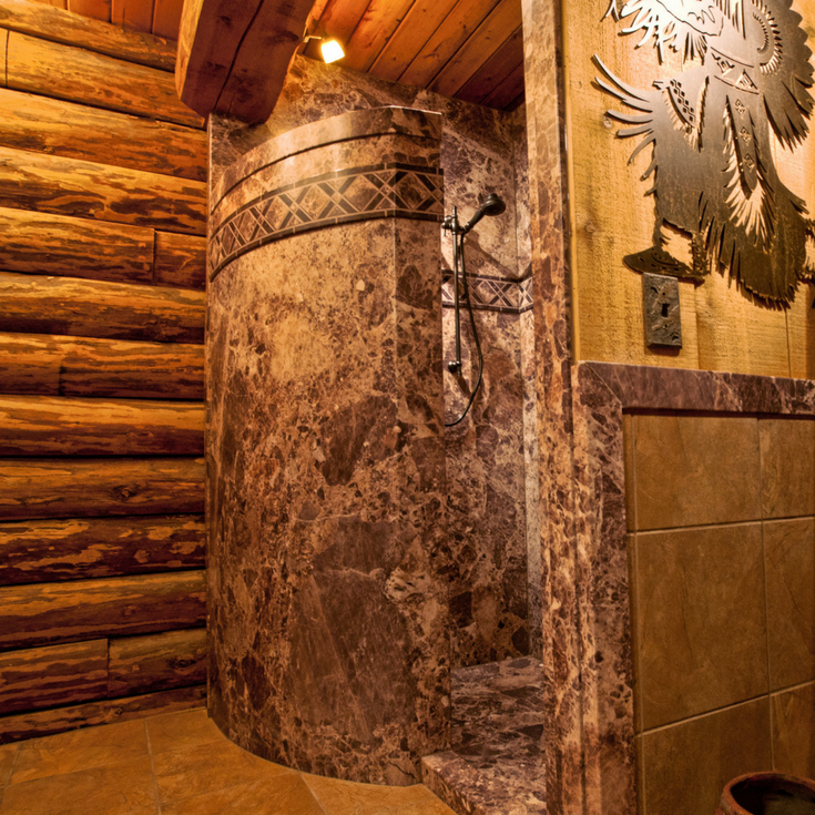 Decorative faux stone shower wall panels used around a custom curved walk in shower | Innovate Building Solutions