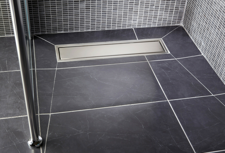 Linear tile shower drain with larger tiles for less grout lines | Innovate Building Solutions 