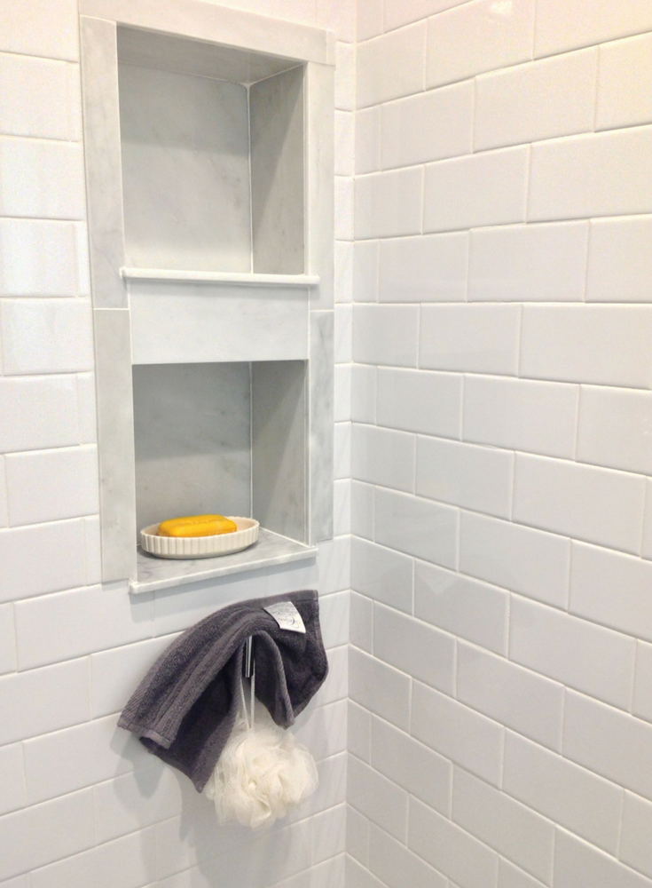 Solid surface subway tile wall panels with a marble recessed niche - Innovate Building Solutions