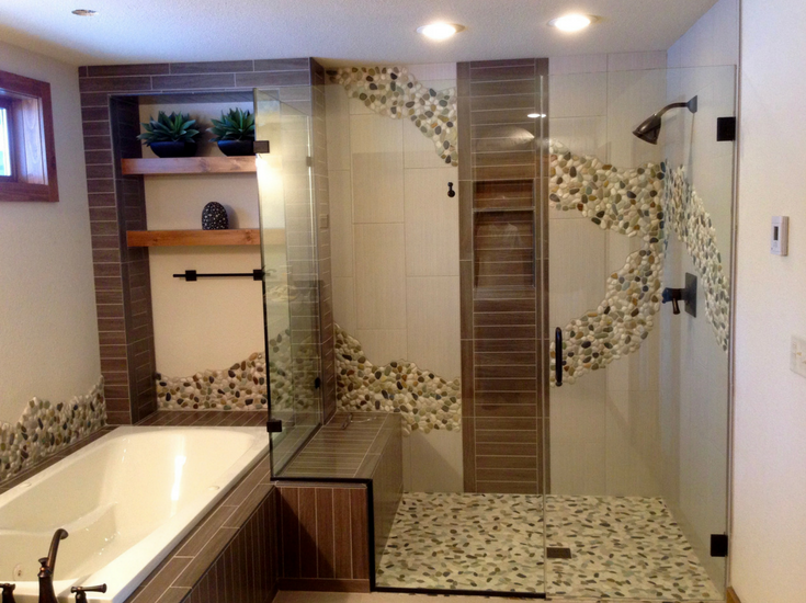 Spa shower with a long bench seat and intricate tile work - Innovate Building Solutions 