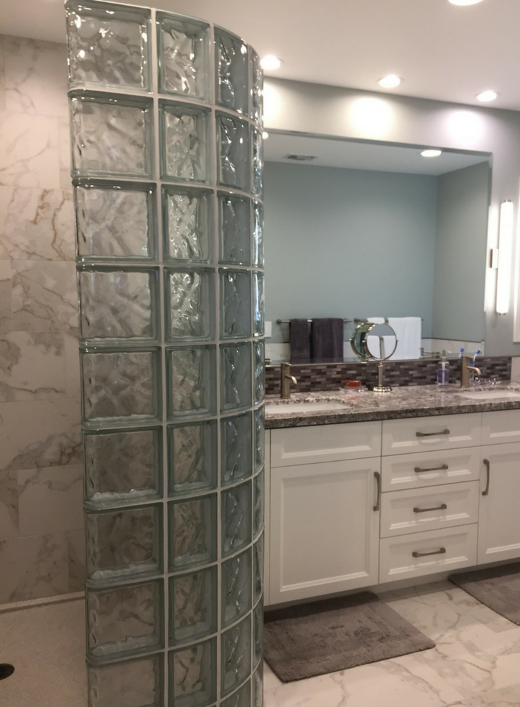 A bathroom remodel in Agoura Hills California with a glass block walk in shower and a double bowl granite vanity top - Innovate Building Solutions