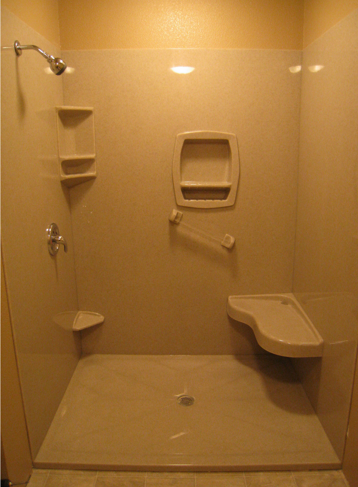 A foot stool recessed niche and bench seat in a solid surface shower | Innovate Building Solutions 