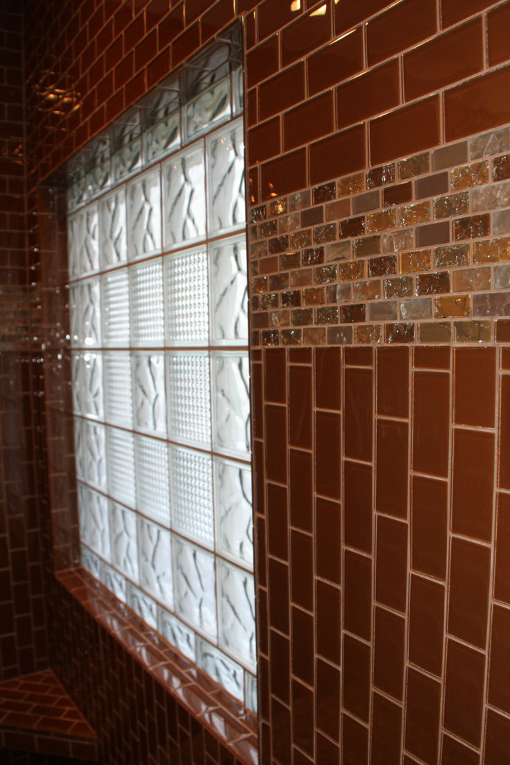 Ceramic tiles return back to a glass block to trim this window | Innovate Building Solutions 