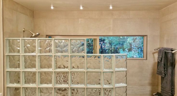 This clear transom window in bathroom remodel in Cazadero California with a curved glass block shower provides excellent views to the towering Redwood trees outside - Innovate Building Solutions 