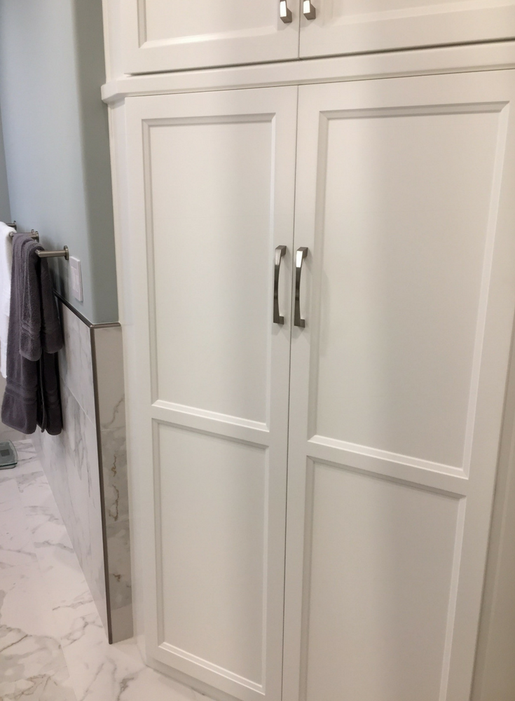 Custom angled shaker style linen cabinet in a bathroom remodel for extra storage - Innovate Building Solutions 