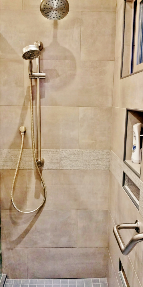 Earth tone colors create a relaxing tile shower stall in this bathroom remodeling in a vacation home in Cazadero California - Innovate Building Solutions 