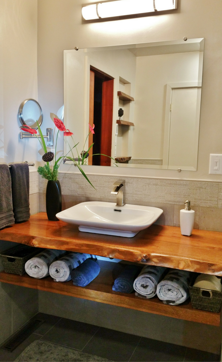 This vanity countertop was made from a bay laurel tree and stained and varnished to bring the outdoors into this bathroom. It was used in a zen-inspired bathroom remodel - Innovate Building Solutions