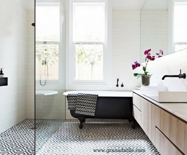 A geometric bathroom tile design in a bathroom with a one level contemporary shower and a clawfoot tub | Innovate Building Solutions 