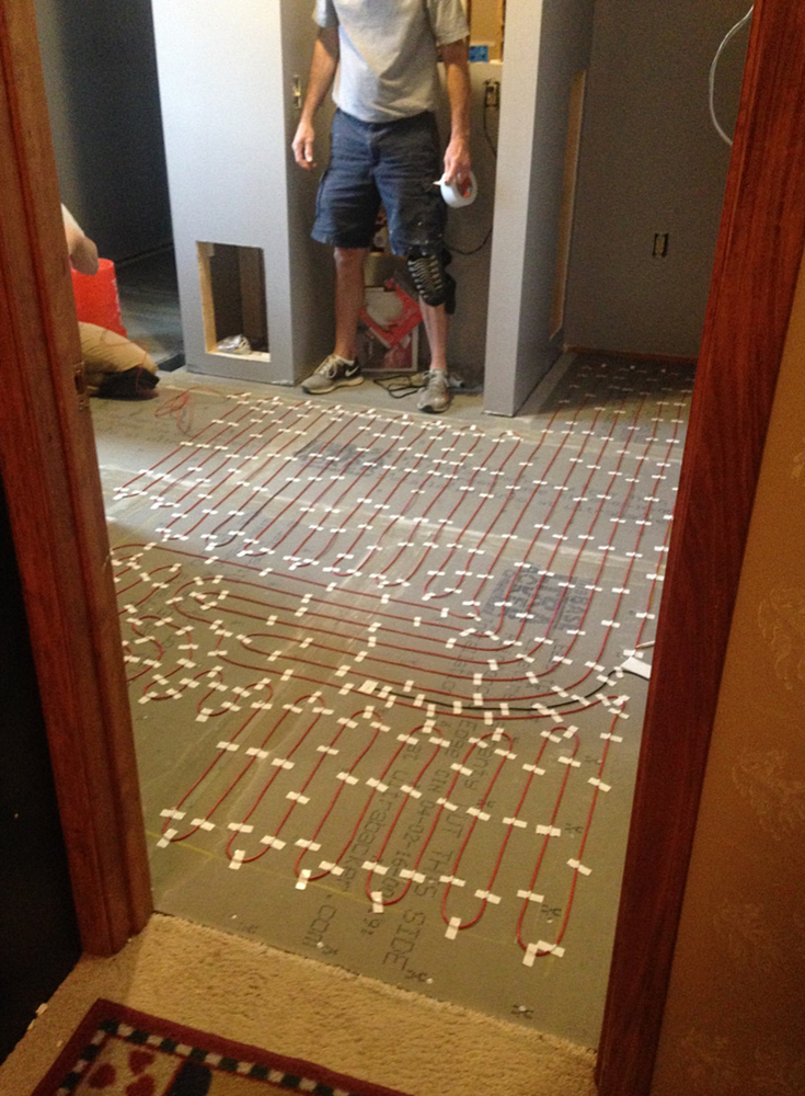 A heated flooring system during installation in a DIY bathroom remodeling project in Columbus Ohio | Innovate Building Solutions 