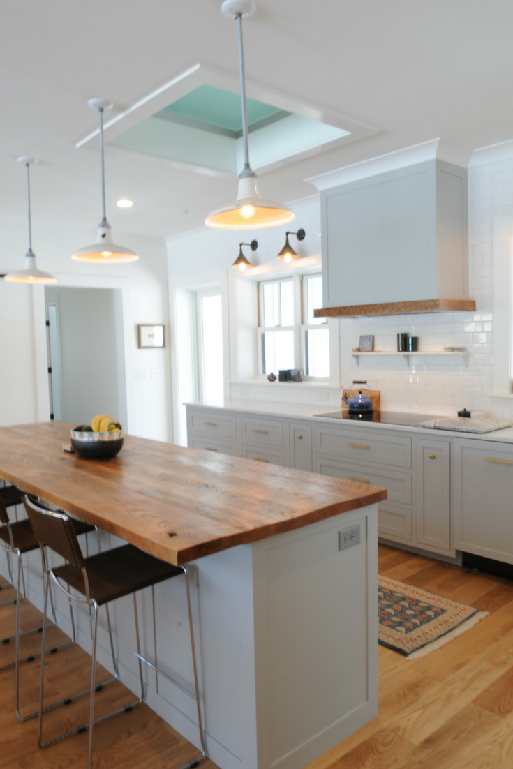 This modern farmhouse custom kitchen has an obscure glass floor panel in the ceiling which moves light into what would have been a darker space through the lofted studio above. | Innovate Building Solutions 