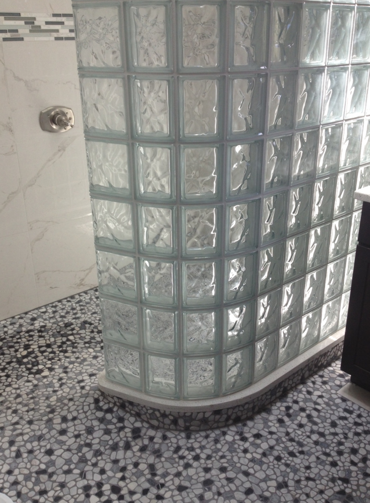 Radius glass block premade shower wall installed on a ready for tile shower pan | Innovate Building Solutions 