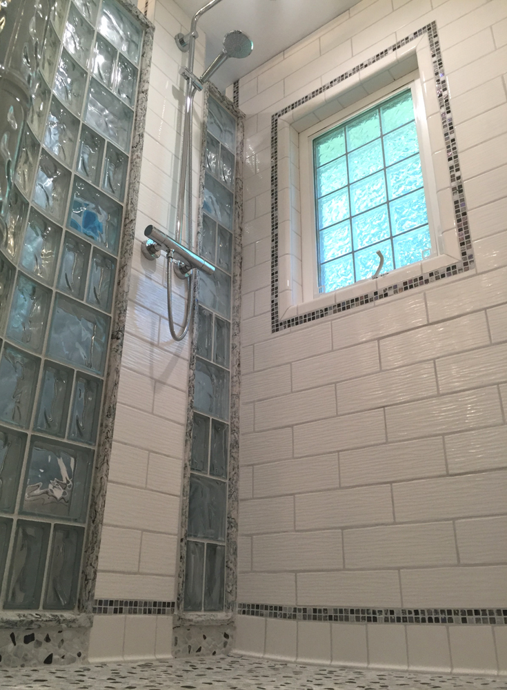 Decorative tile cove base in an upscale small bathroom shower remodeling project in New Jersey | Innovate Building Solutions