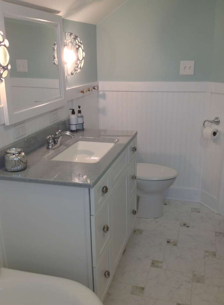 Solid surface bath vanity countertop with shaker cabinets | Innovate Building Solutions