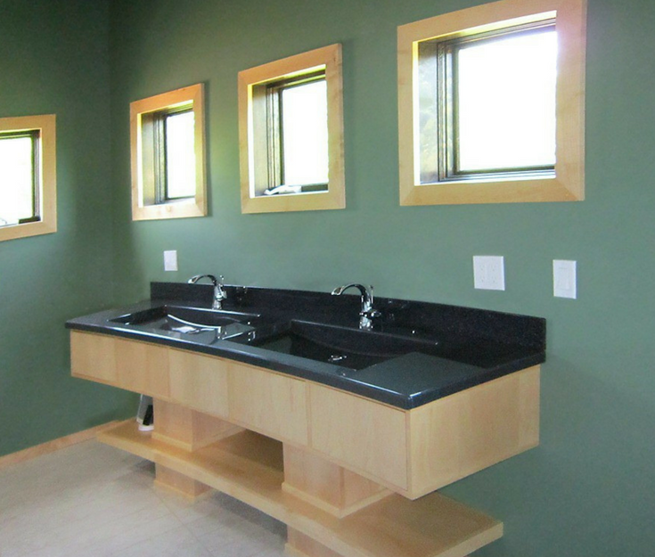 Solid surface black vanity countertop in a contemporary bathroom | Innovate Building Solutions 