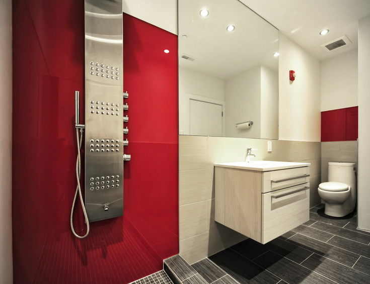 Contemporary fire-engine red high gloss panels with a Euro designed wall hung cabinet create a sleek bathroom space | Innovate Building Solutions 