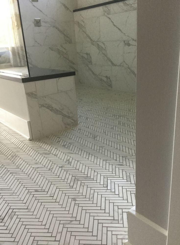 One level barrier free shower finished with a herringbone tile pattern | Innovate Building Solutions 