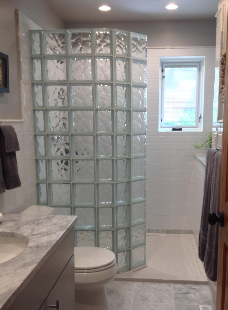 Doorless walk in curved glass block shower and stone pan