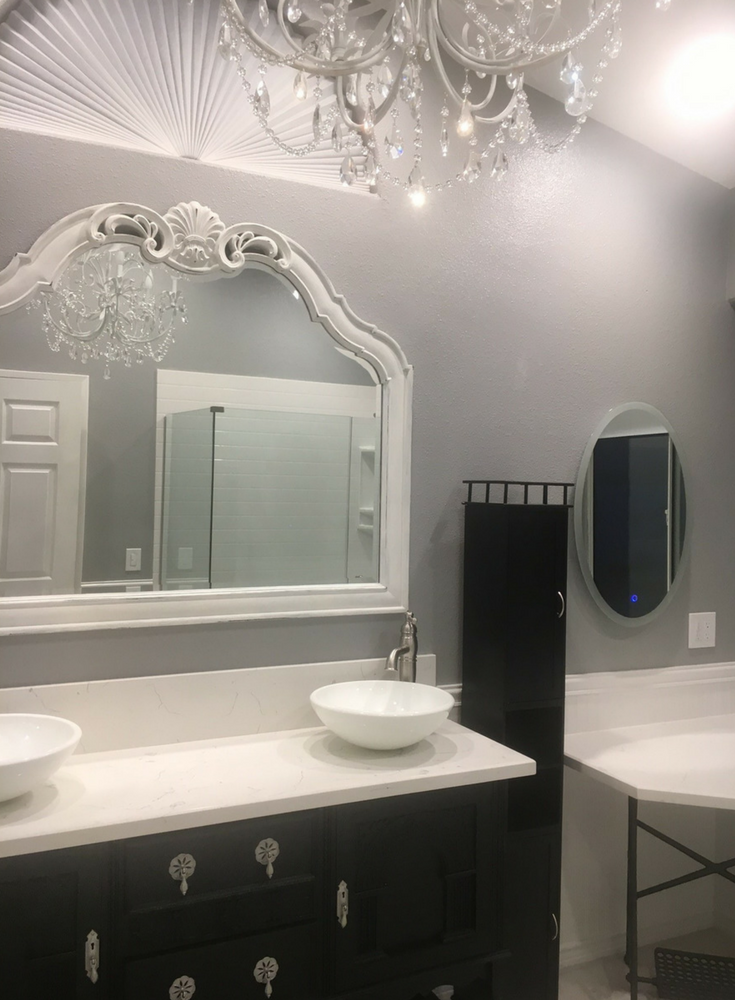 Femine styled vanity and chandelier in a luxury bathroom - Innovate Building Solutions 