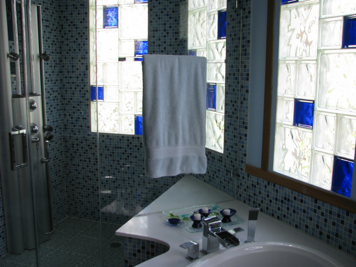 Glass block shower window with random colored glass blocks and sizes | Innovate Building Solutions