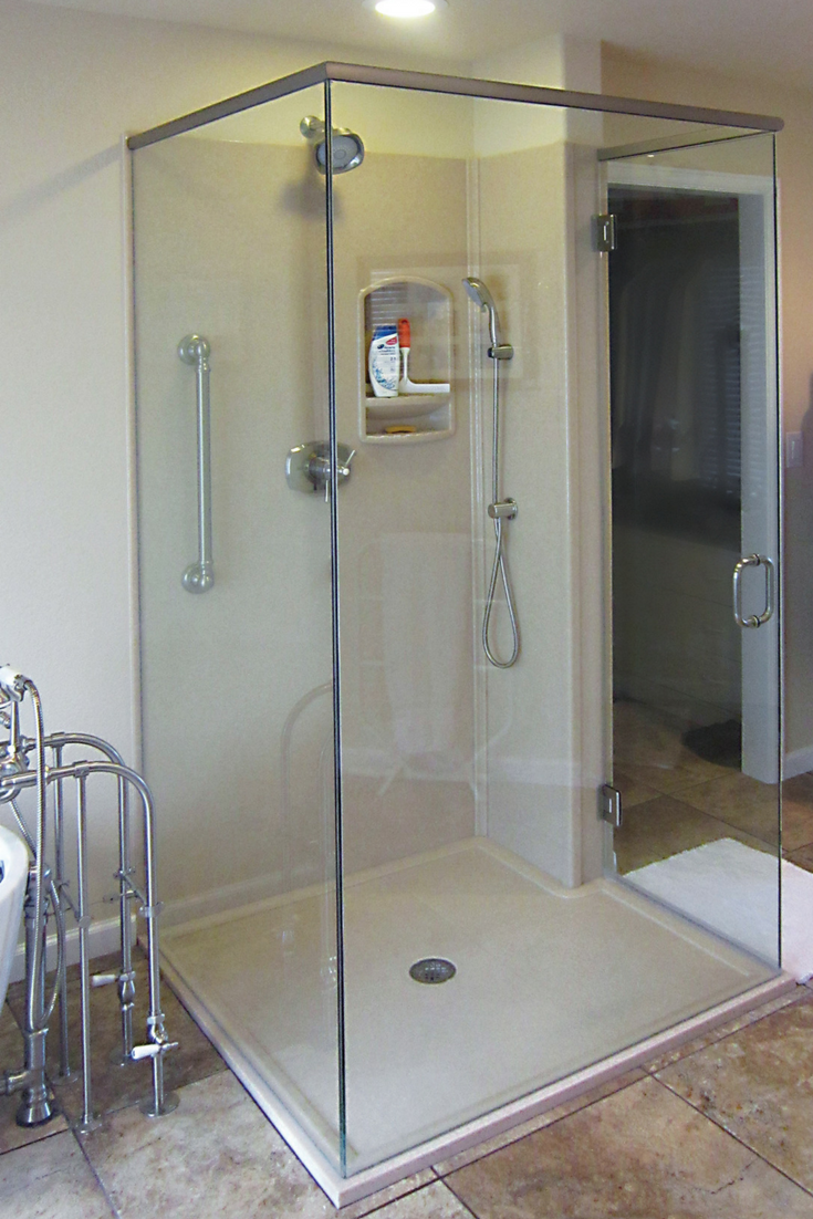 Custom matching solid surface low curb shower base with shower panels | Innovate Building Solutions 