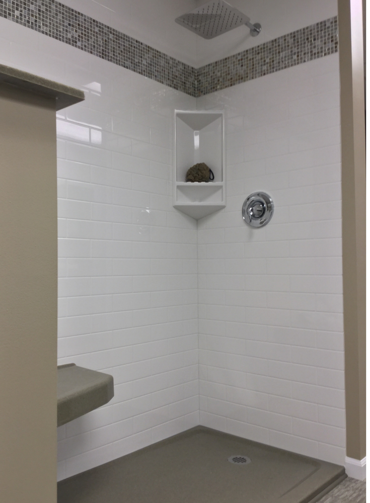 White subway tile looking shower wall panels with a mosaic border | Innovate Building Solutions