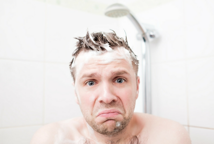 A man not enjoying a cold shower is a reason to remodel a bathroom | 15 Reasons You Shouldn't (and 10 Reasons You Should) Remodel Your Shower | Innovate Building Solutions