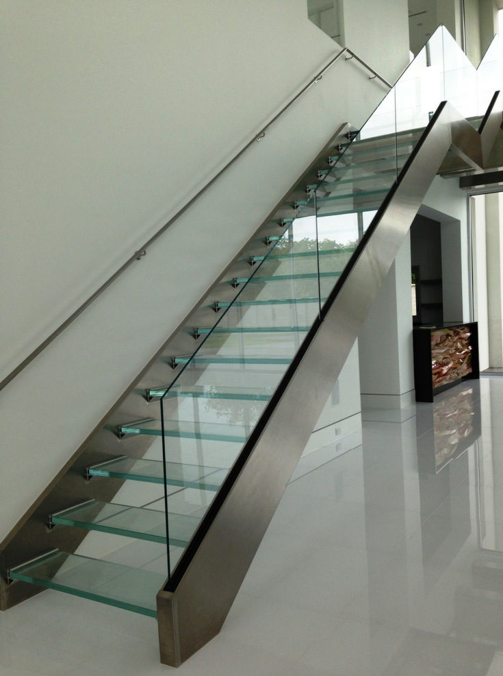 A floating glass staircase in a modern home | Innovate Building Solutions