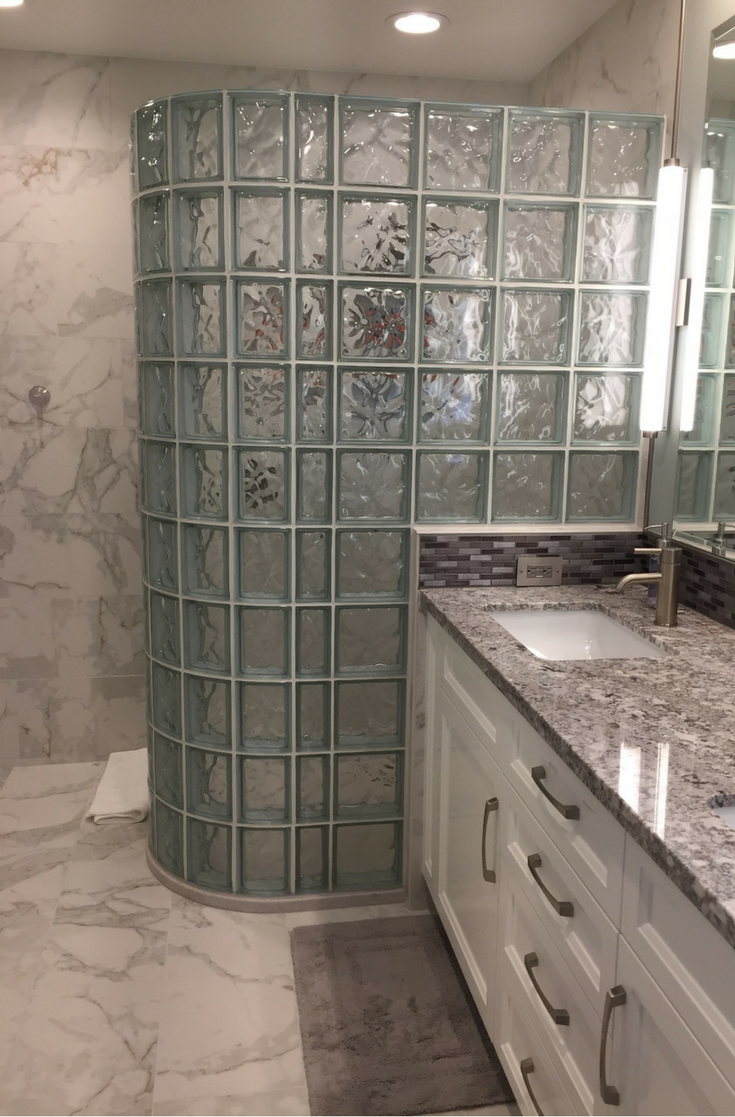 A California bathroom remodeling project with a glass block walk in shower and a solid surface shower base | Innovate Building Solutions 